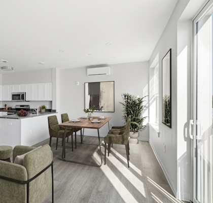 A modern kitchen with a dining table and chairs.
