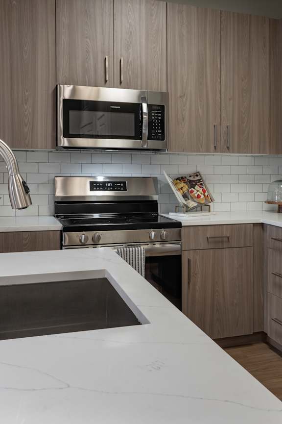 A modern kitchen with a dining table and chairs at The Waverly at Winter Haven Apartments, Winter Haven, 33884