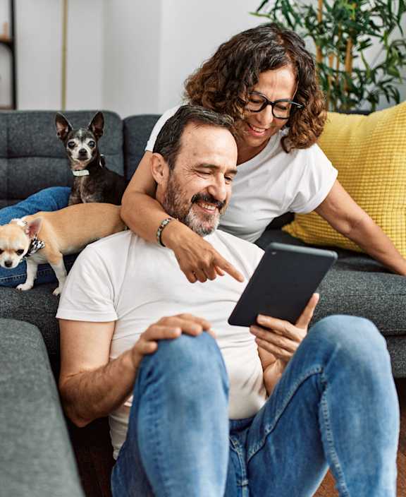 stock photo happy couple with a dog in their new home
