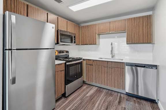 a kitchen with stainless steel appliances and wooden cabinets