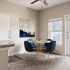 a living room with brown chairs and a table