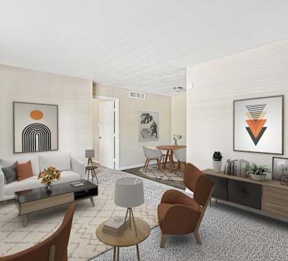 A living room with a white couch, a coffee table, and a few chairs.