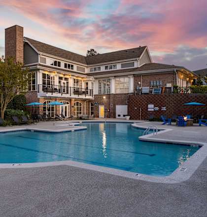 A large house with a pool in front.