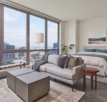 a bedroom with a bed and a large window