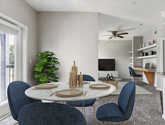 an open living room with a dining room table and chairs