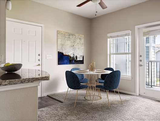 a dining room with a round table and blue chairs