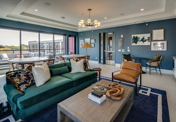 a living room with blue walls and a green couch