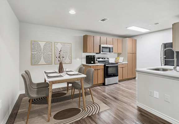 a kitchen and dining room with a table and chairs