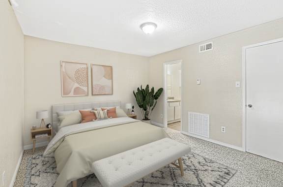 A bedroom with a large bed and a bench in the middle of the room.