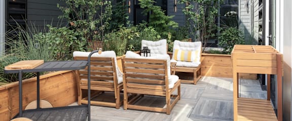 A wooden patio with a table and chairs.