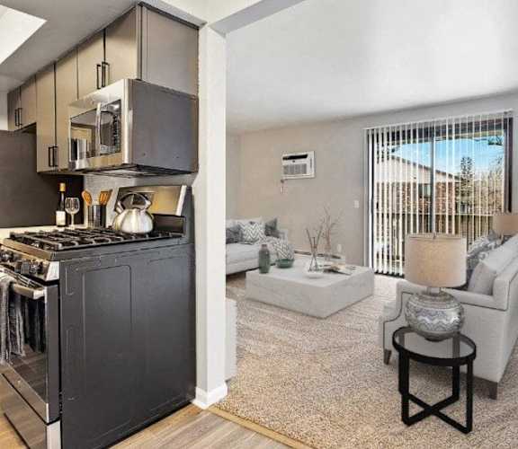 an open living room with a kitchen and a living room