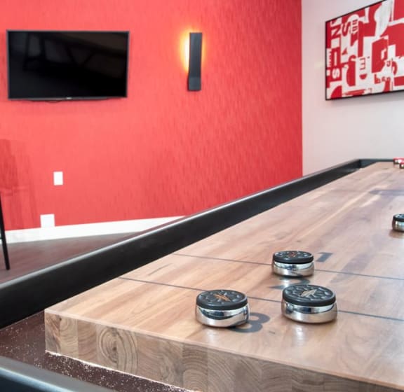 a table and chairs in a room with a television in the background