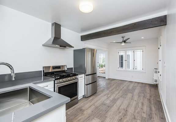a kitchen with a stove top oven next to a window