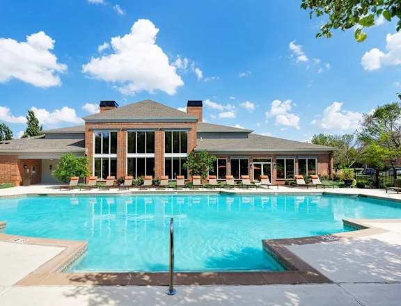 A large house with a pool in front.
