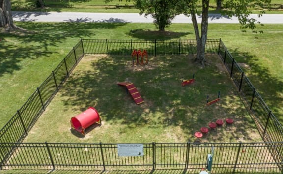an aerial view of a dog park with a dog kennel and playground equipment