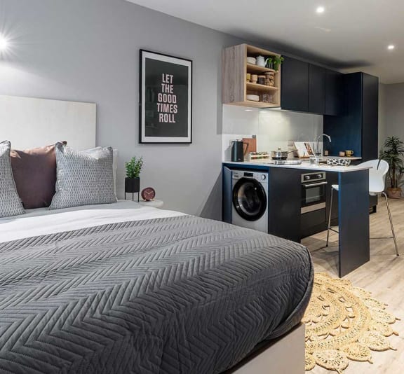 a bedroom with a bed and a laundry room