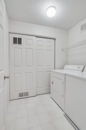 Thumbnail 12 of 27 - laundry room with washer/dryer and white doors and white floors