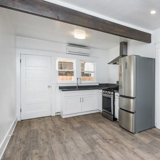 a kitchen with a stainless steel refrigerator freezer and a stove top oven