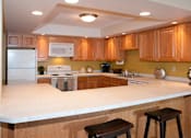 Thumbnail 4 of 14 - Community kitchen with appliances and C-shaped table