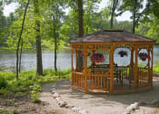 Thumbnail 14 of 23 - wooden gazebo surrounded by trees overlooking a lake