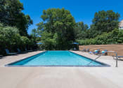 Thumbnail 10 of 23 - long shot of outdoor pool with trees in the background