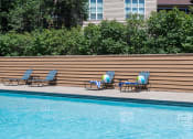 Thumbnail 12 of 23 - poolside lounge chairs on a sunny day