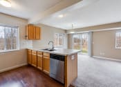 Thumbnail 2 of 22 - kitchen island overlooking empty, carpeted living room