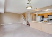 Thumbnail 5 of 22 - carpeted living room with view of the stairs and kitchen
