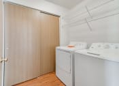 Thumbnail 11 of 22 - laundry room with tan sliding closet doors
