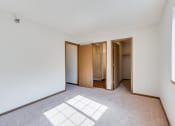 Thumbnail 8 of 22 - bedroom with open doors leading to a closet, a bathroom, and a hallway