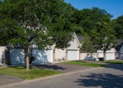 Thumbnail 14 of 22 - row of houses with garages and two large trees out front