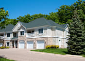 Thumbnail 15 of 17 - Townhome surrounded by lush green trees and grass