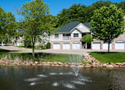 Thumbnail 14 of 17 - Townhome overlooking a lake with a fountain in it