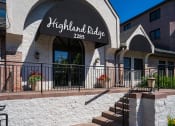 Thumbnail 19 of 22 - Exterior shot with stairs leading to front door and a black awning with the words "Highland Ridge 2285" written in white