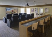 Thumbnail 16 of 23 - Theater room with rows of leather chairs and bar seating