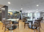 Thumbnail 14 of 26 - Community room with tables and chairs