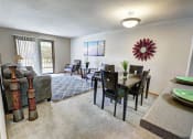Thumbnail 2 of 26 - Dining and living room with a couch, chairs, and a dining table