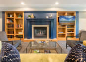 Thumbnail 10 of 27 - Fireplace surrounded by shelves and seating and a TV mounted to the right