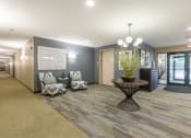 Thumbnail 7 of 27 - Lobby with seating and a plant on an artistic table