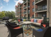 Thumbnail 17 of 27 - Outdoor deck with patio seating and a grill