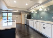 Thumbnail 12 of 27 - Community kitchen with a stovetop, sink, and refrigerator