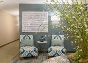 Thumbnail 8 of 27 - Apartment entryway with seating, artwork, and a large plant