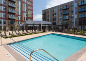 Thumbnail 7 of 42 - Outdoor pool with lounge chairs on the pool deck