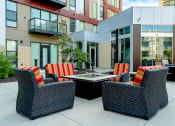 Thumbnail 34 of 42 - Patio seating surrounding a square fireplace table