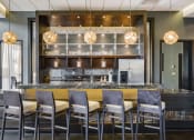 Thumbnail 32 of 42 - Community room with bar seating in front of long community kitchen island