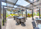 Thumbnail 25 of 42 - Outdoor seating under a sun terrace with heat lamps hanging above
