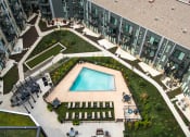 Thumbnail 38 of 42 - Aerial shot of center of the property, with walking paths and a pool in the center