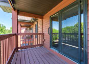 Thumbnail 19 of 26 - Maroon colored wooden deck and a sliding glass door