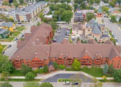 Thumbnail 23 of 26 - Aerial drone shot of property, with nearby buildings in view