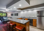 Thumbnail 12 of 26 - Community room kitchen with a U shaped bar
